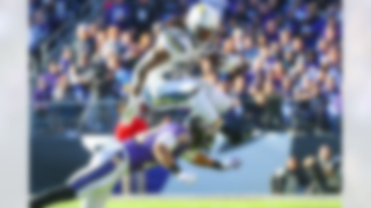 Los Angeles Chargers running back Melvin Gordon (28) hurdles over Baltimore Ravens cornerback Jimmy Smith (22) on 6-yard pickup a during a NFL wild card football game, Sunday, Jan. 6, 2019, in Baltimore.