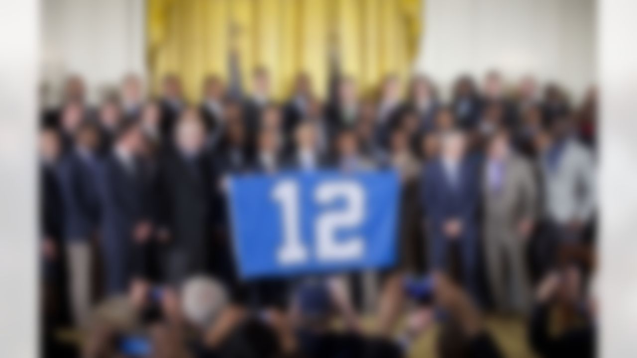 President Barack Obama holds up a banner with a "12" for a group photo as he welcomes the NFL Super Bowl champion Seattle Seahawks football team to the East Room of the White House in Washington, Wednesday, May 21, 2014. The Seahawks defeated the Denver Broncos in Super Bowl XLVIII. (Pablo Martinez Monsivais/Associated Press)