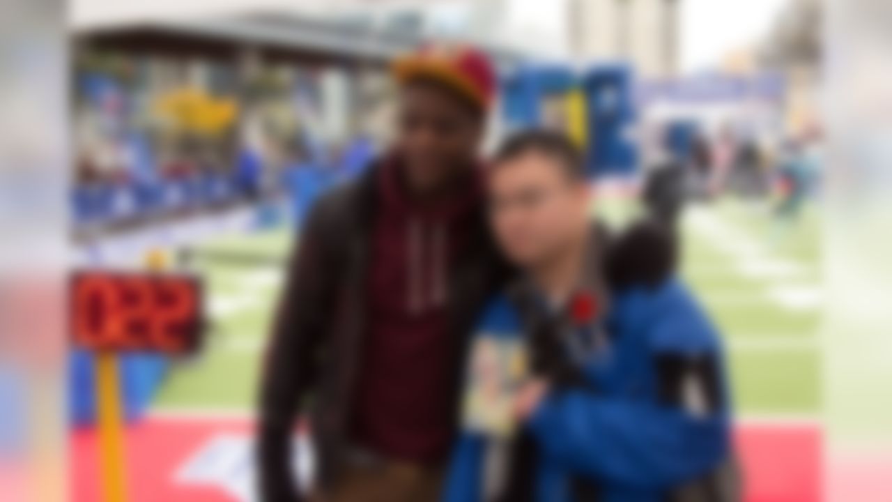 Former Washington Redskins running back Clinton Portis signs autographs and poses for photos with NFL fans as they take part in a NFL Experience event in Toronto, Canada. (National Football League)