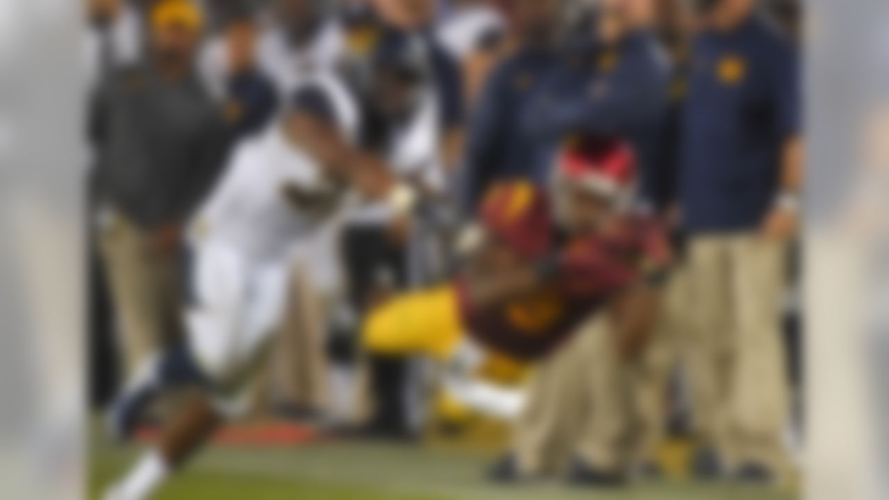 Southern California wide receiver JuJu Smith, right, makes a diving catch under pressure by California cornerback Cedric Dozier during the second half of an NCAA college football game, Thursday, Nov. 13, 2014, in Los Angeles. The play was called back after video review showed that Smith did not maintain control of the ball when he hit the ground. (AP Photo/Mark J. Terrill)