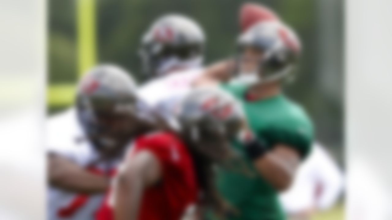 Tampa Bay Buccaneers quarterback Josh Freeman, right, throws during a workout at NFL football training camp, Saturday, July 28, 2012, in Tampa, Fla. (AP Photo/Mike Carlson)
