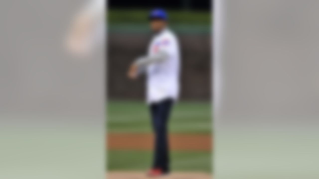 Chicago Bears cornerback Kyle Fuller throws out the ceremonial first pitch before a baseball game between the Chicago Cubs and Cincinnati Reds on Wednesday, April 13, 2016, in Chicago. (AP Photo/Paul Beaty)