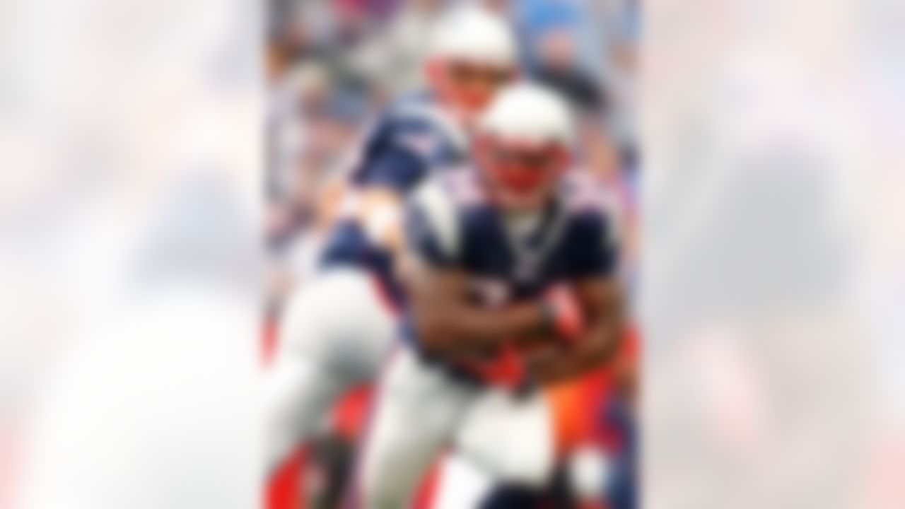 FOXBORO, MA - OCTOBER 07: Sammy Morris #34 of the New England Patriots takes the ball from quarterback Tom Brady #12 in the fourth quarter against the Cleveland Browns on October 7, 2007 at Gillette Stadium in Foxboro, Massachusetts. The Patriots defeated the Browns 34-17. (Photo by Elsa/Getty Images)