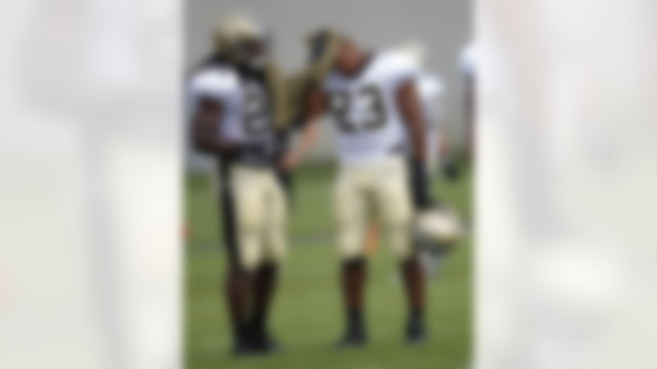 New Orleans Saints running back Pierre Thomas (23) and running back Chris Ivory (29) share a towel during NFL football training camp in Metairie, La., Saturday, July 28, 2012. (AP Photo/Gerald Herbert)