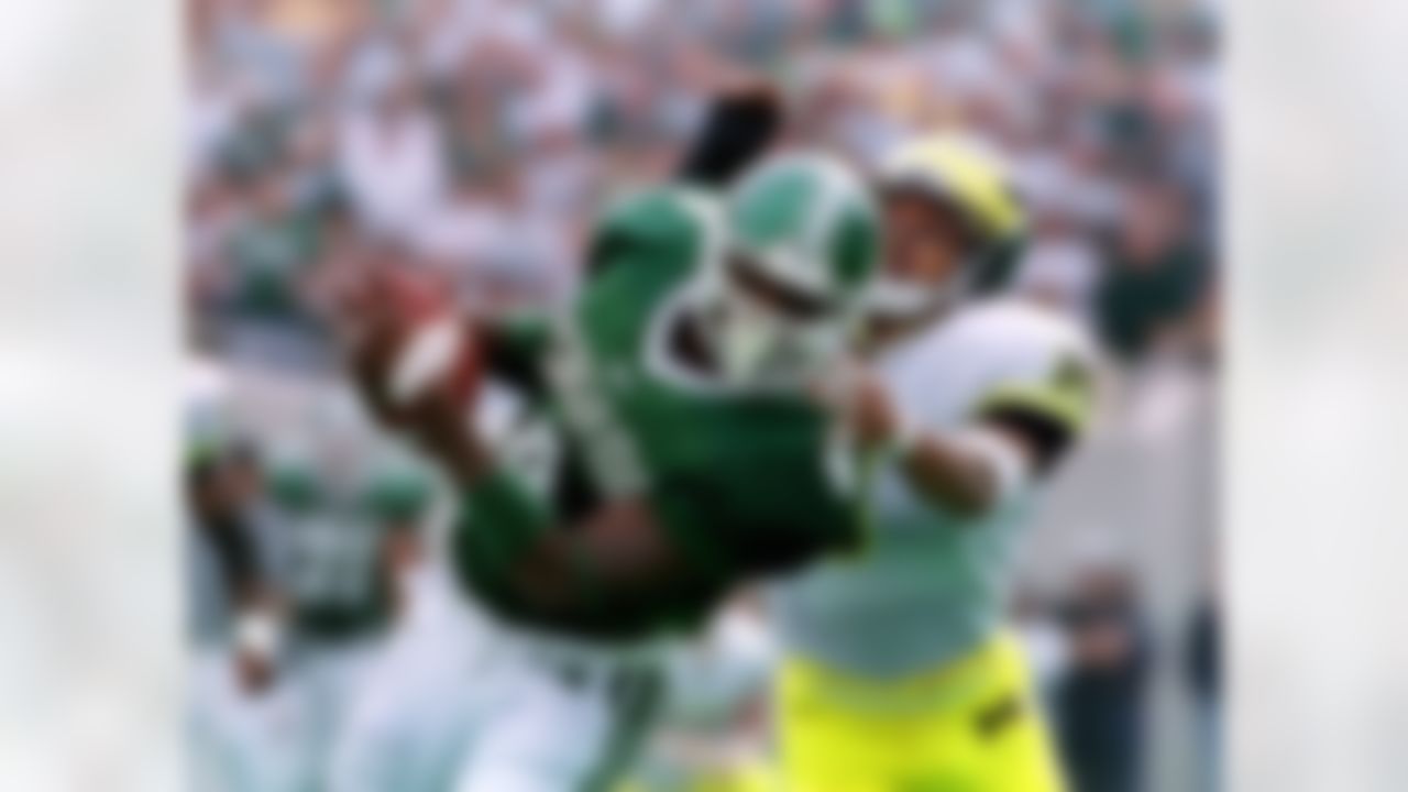 FILE - In this Oct. 9, 1999, file photo, Michigan State receiver Plaxico Burress (4) pulls in a pass defended by Michigan cornerback Todd Howard during the second quarter of an NCAA college football game at Spartan Stadium in East Lansing, Mich. Michigan State defeated Michigan 34-31. The two 5-0 schools meet in Ann Arbor on Saturday, Oct. 10, 2010. (AP Photo/Werner Slocum, File)