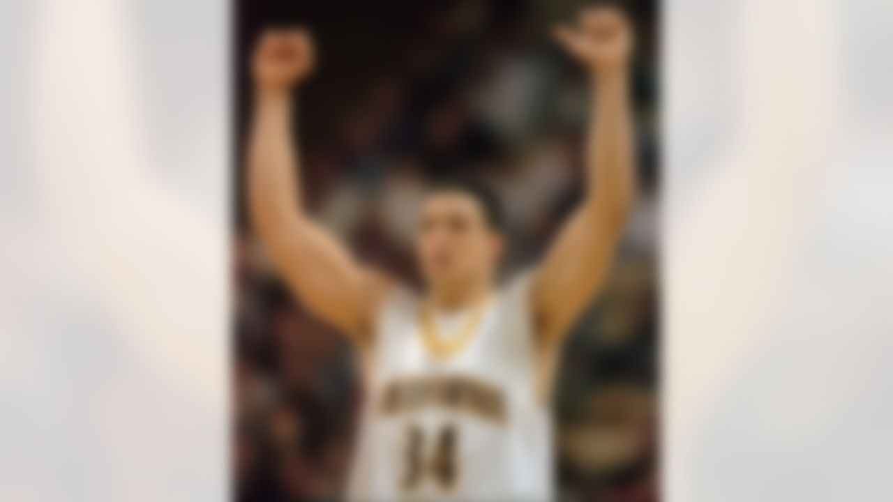 California forward Tony Gonzalez raises his arms in victory after the Golden Bears defeated the Princeton Tigers 55-52 in the first round of the NCAA East Regional tournament on Thursday, March 13, 1997, in Winston-Salem, N.C. Gonzalez scored all five of Califonia's points in the last minute to secure the victory. (AP Photo/John Bazemore)