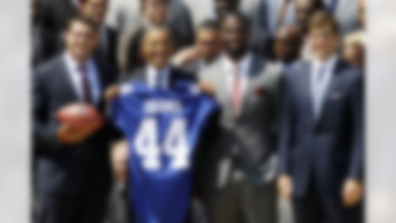 President Barack Obama poses with New York football Giants captains, from left: Zak DeOssie; Justin Tuck; Eli Manning, on the South Lawn at the White House in Washington, Friday, June 8, 2012, during a ceremony where the president honored the Super Bowl XLVI champions New York Giants. (AP Photo/Charles Dharapak)