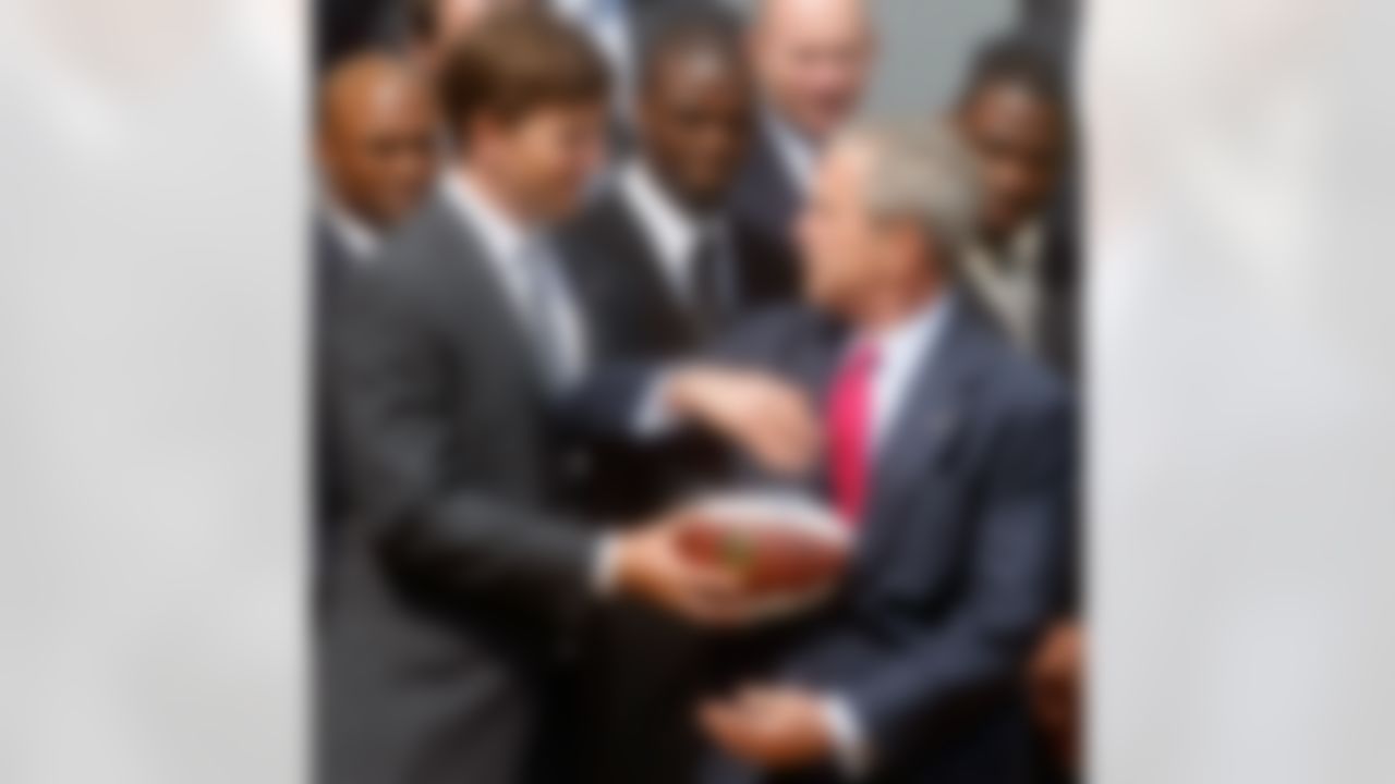 WASHINGTON - APRIL 30: Quarterback Eli Manning hands off a souvenir football to President George W. Bush during a event to honor the Super bowl XLII Champion New York Giants on the south lawn of the White House, April 30, 2008 in Washington DC. Last February the Giants beat the New England Patriots 17 to 14, in one of the biggest upsets in Super Bowl history. (Photo by Mark Wilson/Getty Images)