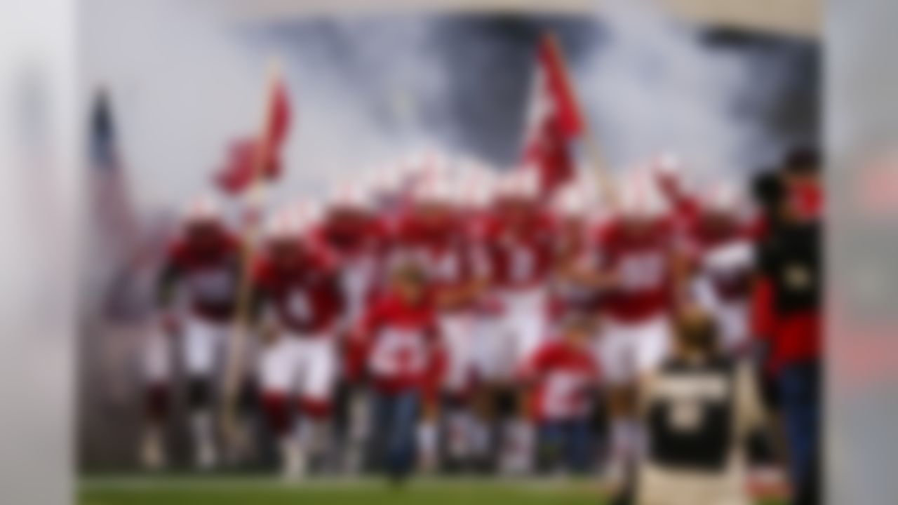 Nephews of deceased Nebraska punter Sam Foltz, Lane Foltz, left, and Max Foltz, right, join the team as they run onto the field, before an NCAA college football game against Fresno State in Lincoln, Neb., Saturday, Sept. 3, 2016. (AP Photo/Nati Harnik)