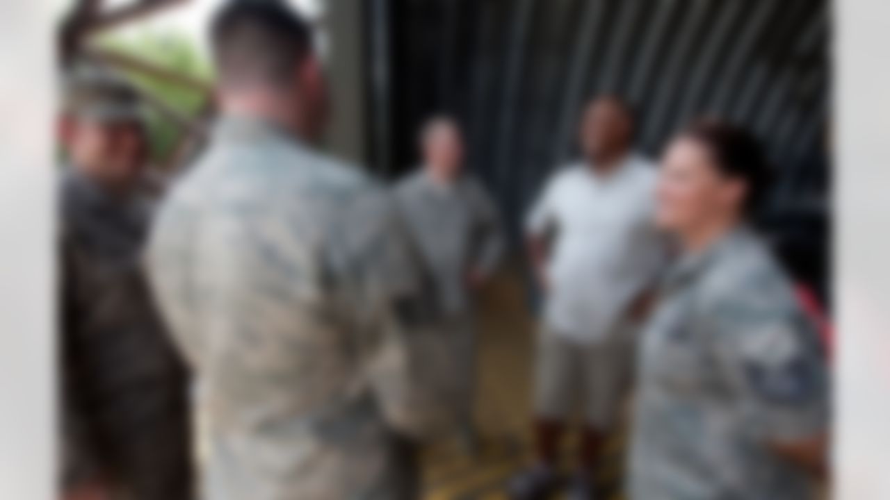 Cincinnati Bengals head coach Marvin Lewis (2nd r) talks with airmen at the 435th Air Mobility Squadron at Ramstein Air Base in Germany during a USO/Armed Forces Entertainment tour stop on June 30, 2010. This is thefirst overseas USO tour for Lewis and he is joined by three other top NFL coaches who are touring bases in Germany and the Persian Gulf. (Fred Greaves/USO)