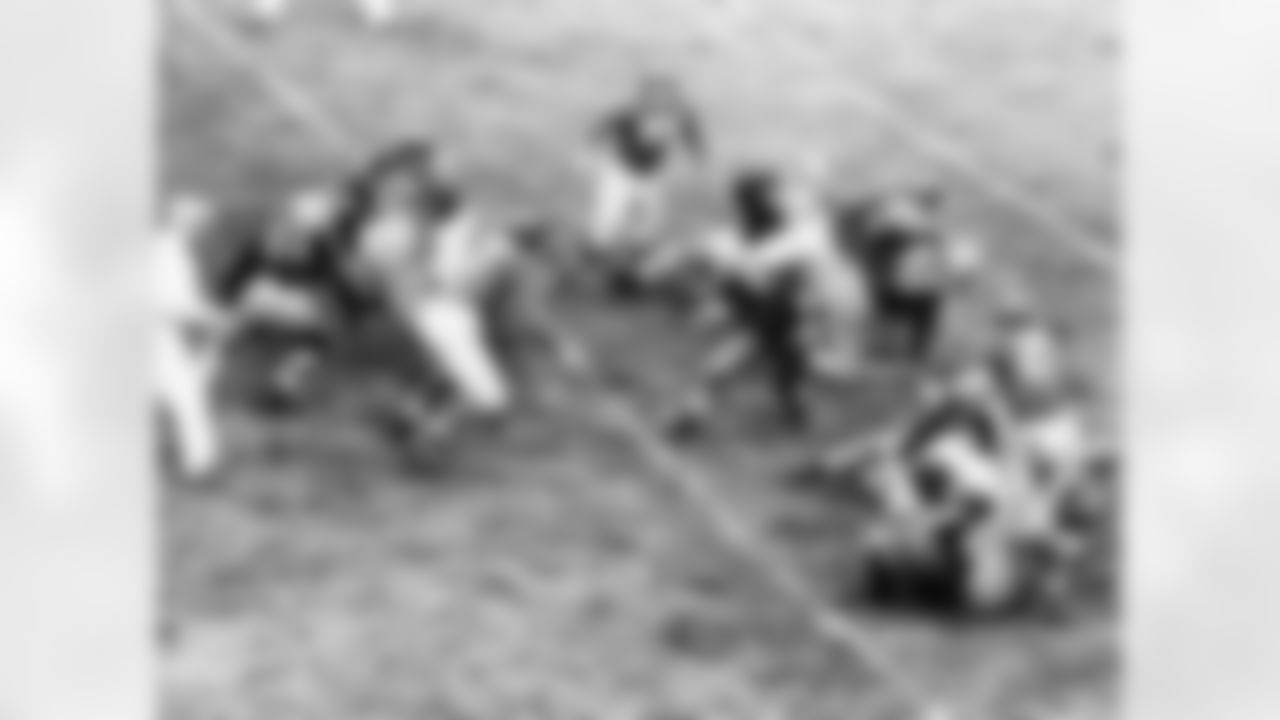 Andy Uram of the Green Bay Packers cracks through a hole in the center of the line to run smack into Mel Hein (7) New York Giants center, in the first quarter of a National Professional Football League game in New York City, Nov. 17, 1940. Uram made just one yard on the play. The Giants won, 7-3. Identifiable players: Packers Pete Tinsley (21) guard Bill Lee (40) tackle and George Svendsen (66) center; Giants Jim Poole (23) end. (Associated Press)