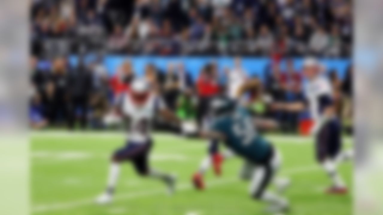 New England Patriots wide receiver Brandin Cooks (14) runs the ball as Philadelphia Eagles defensive end Chris Long (56) defends.