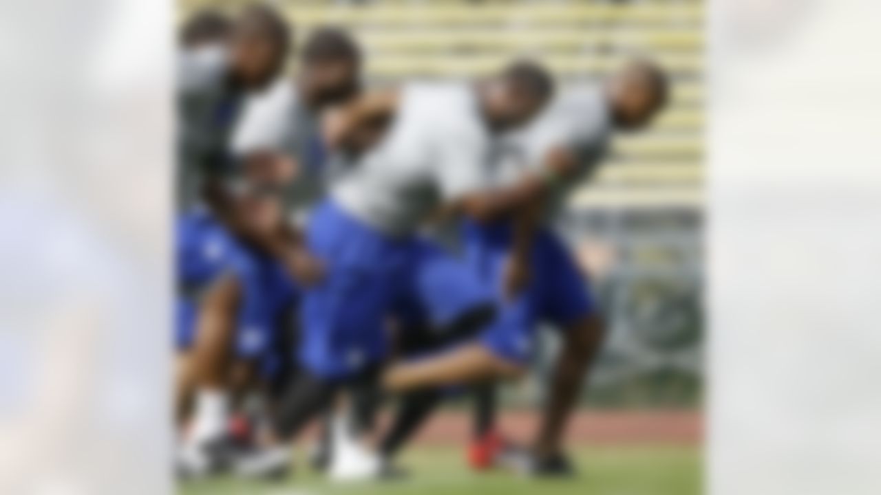 New York Giants defensive end Justin Tuck, center, runs with teammates during a physical evaluation on opening day of NFL football training camp in Albany, N.Y., Thursday, July 26, 2012. (AP Photo/Kathy Willens)