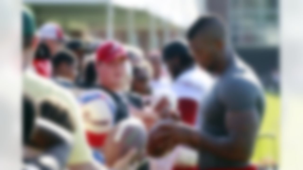 Atlanta Falcons' Ray Edwards signs autographs after NFL football training camp in Flowery Branch, Ga., Thursday, July 26, 2012. (AP Photo/John Bazemore)