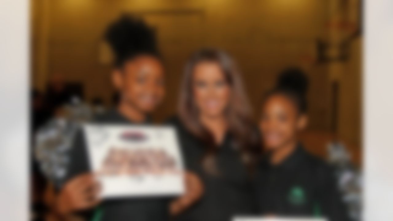 An Atlanta Falcons cheerleader poses for a photo with students at a local school on Thursday, Oct. 23, 2014 in Brixton, South London. (Nicky Hayes/NFL)