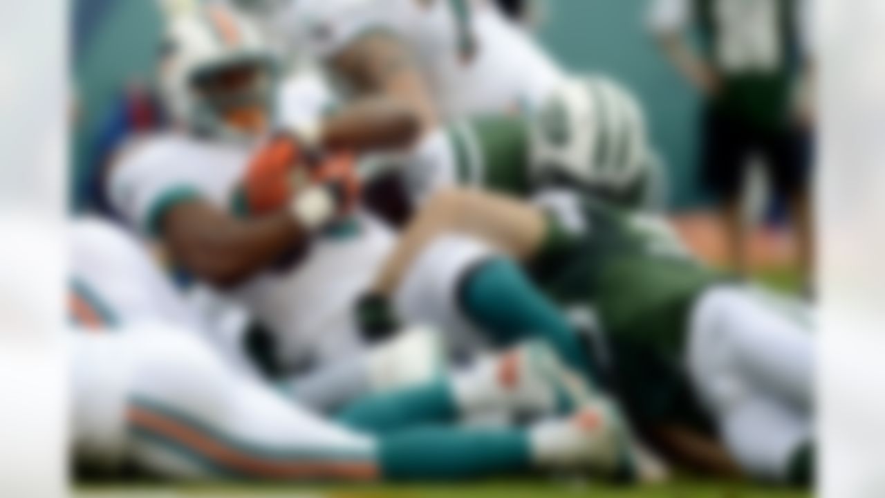 Miami Dolphins running back Daniel Thomas (33) scores a touchdown during the first half of an NFL football game against the New York Jets, Sunday, Sept. 23, 2012, in Miami. (AP Photo/Rhona Wise)