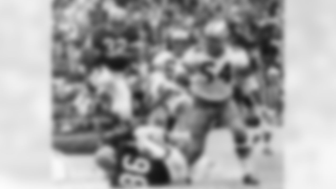 Cleveland Browns fullback, Jim Brown leaps for a gain over right tackle and fellow player Gary Collins (86) in third quarter, in their game with the Dallas Cowboys in Dallas on Oct. 19, 1964. Watching are Cowboy players George Andrie (66) and Chuck Howley (54). (Associated Press)