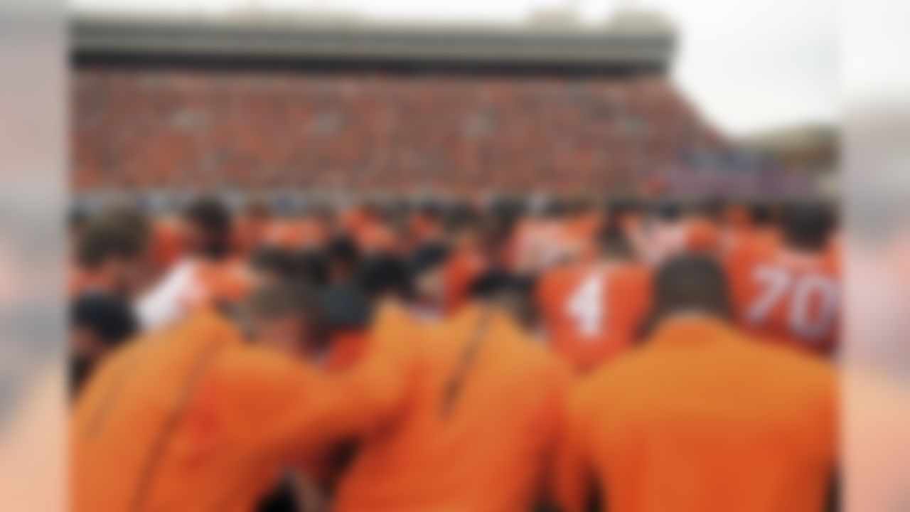 Oklahoma State players and staff form a prayer circle prior to an NCAA college football game between Kansas and Oklahoma St in Stillwater, Okla., Saturday, Oct. 24, 2015. Earlier in the day tragedy struck at the Oklahoma State homecoming parade as a car ran into a group of parade watchers killing at least three and injuring dozens more. (Brody Schmidt/Associated Press)