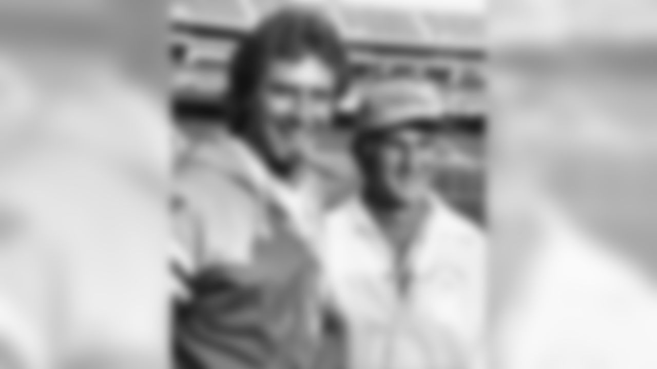 Miami Dolphins quarterback Dan Marino, left, and Coach Don Shula get together for photographers during media day at Oakland Stadium Tuesday, Jan. 15, 1985, Oakland, Calif. The Dolphins play the San Francisco 49ers Sunday in Super Bowl XIX to be played at Stanford Stadium in nearby Palo Alto. (AP Photo)