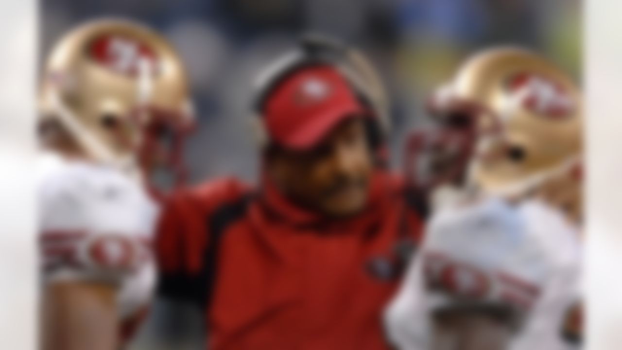 San Francisco 49ers running backs coach Bishop Harris talks with Maurice Hicks, left, and Frank Gore, right, during 24-14 victory over the Seattle Seahawks in NFL Network Thursday Night Football game at Qwest Field in Seattle, Wash. on December 14, 2006. Photo by Getty Images.