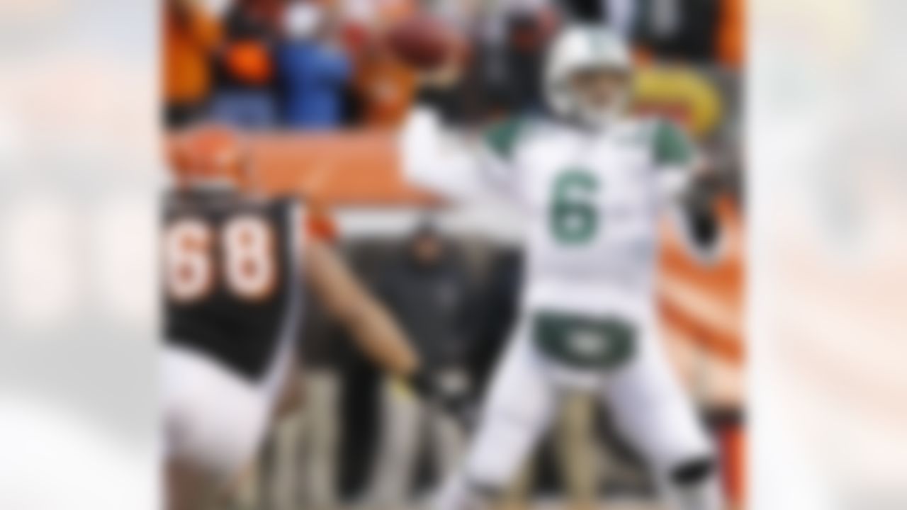 New York Jets quarterback Mark Sanchez (6) passes under pressure from Cincinnati Bengals defensive end Jonathan Fanene (68) in the first half of an NFL wild-card playoff football game, Saturday, Jan. 9, 2010, in Cincinnati. (AP Photo/Ed Reinke)