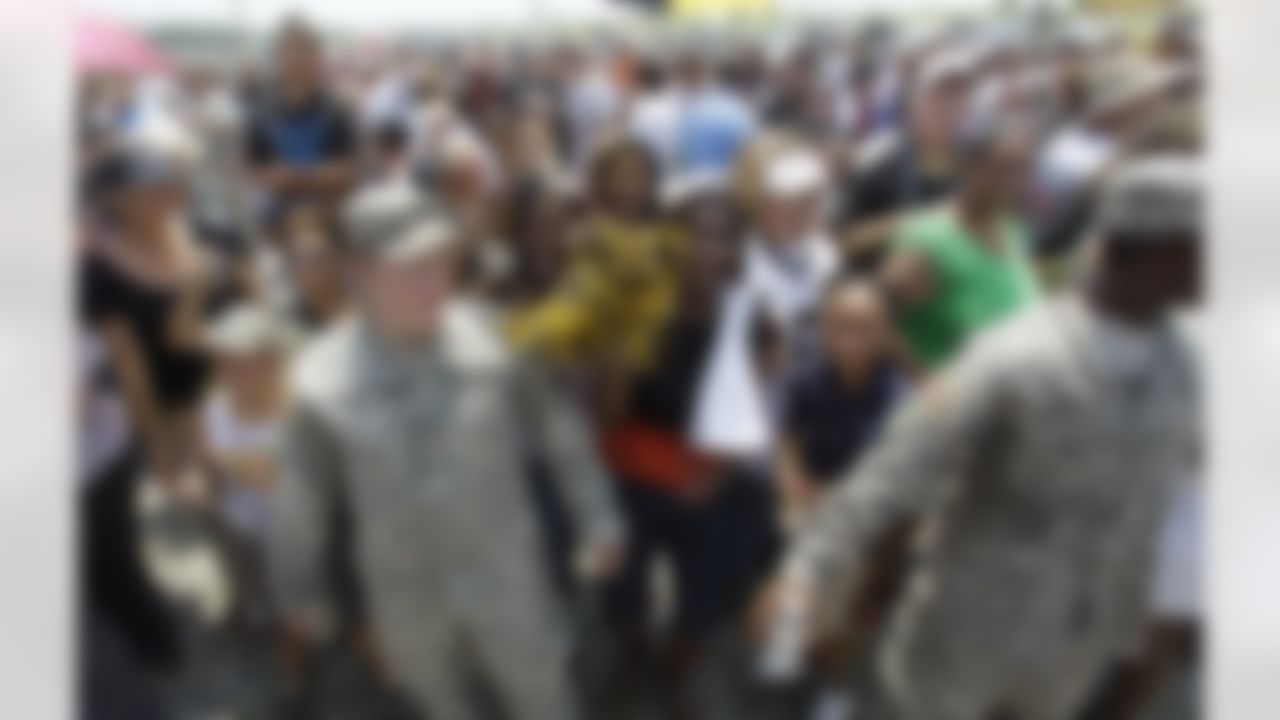 National Guard soldiers help control the crowd as the New Orleans Saints make a visit to Buras, La. for a rally, Tuesday, June 8, 2010. The Saints made a visit to the to the area to boost moral. (AP Photo/Eric Gay)