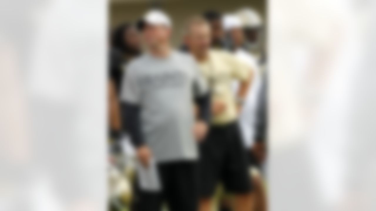 New Orleans Saints offensive coordinator Pete Carmichael, left, and defensive coordinator Steve Spagnuolo run drills during NFL football training camp in Metairie, La., Saturday, July 28, 2012. (AP Photo/Gerald Herbert)