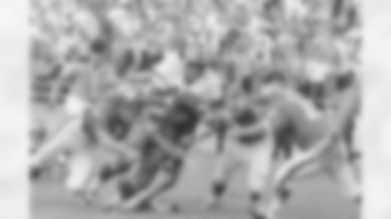 Syracuse Orangemen's Floyd Little (44) keeps charging down the field despite efforts of Baylor's Willie Walker (83) and Paul Ortiz (30) trying to stop the hard running halfback during third quarter of their game on Sept. 12, 1966 at Baylor Stadium in Waco, Texas. Coming in to assist on the play are O.B. Goolsby (50) and Bob Purvis (18). Baylor won the non-conference game, 35-12. (Associated Press)