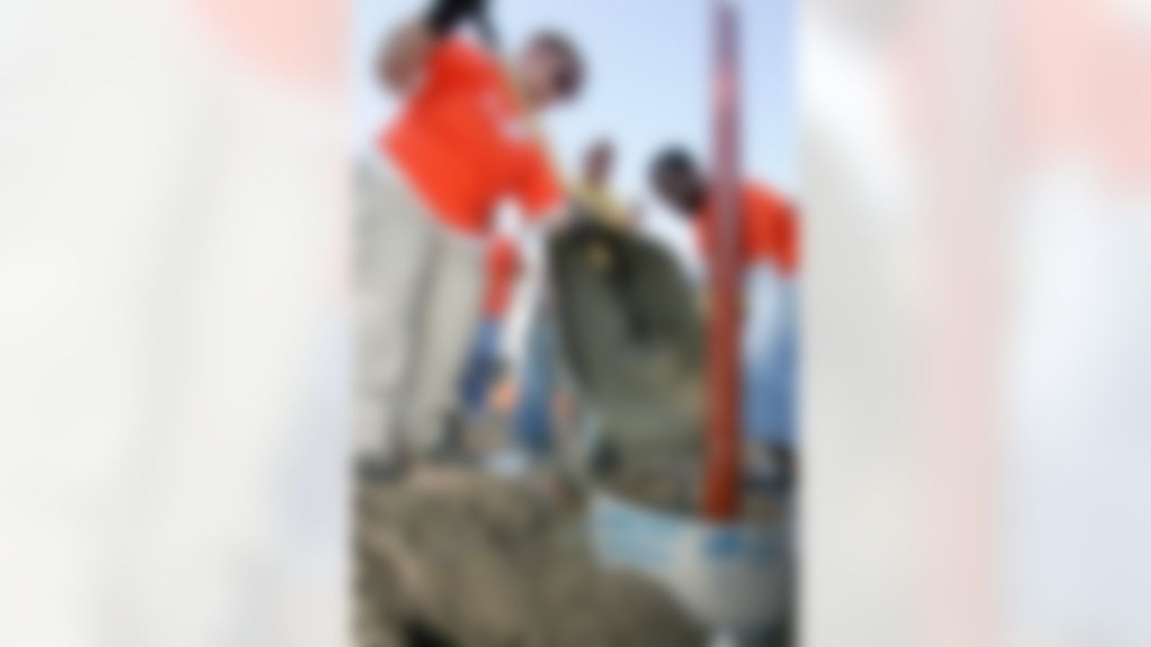 The Home Depot volunteers pour concrete to help build the base of the structure. (Photo by Alan Marler/CIA Stock Photography, Inc.)