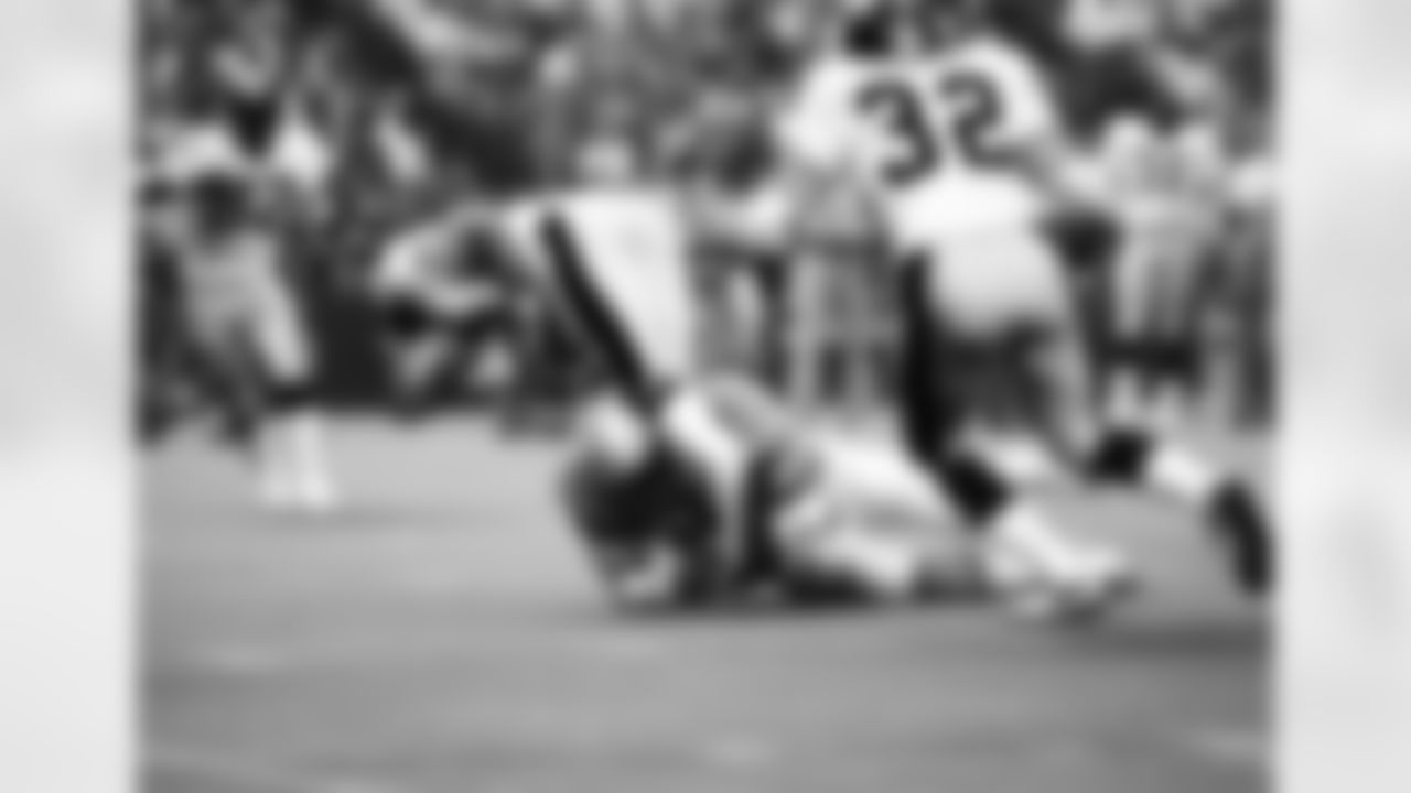 Pittsburgh Steelers rookie safety Tony Dungy (21), who took over as quarterback after Terry Bradshaw and Mike Kruczek left the game with injuries, fumbles the ball after being hit by Houston Oilers Robert Brazile (52), in Houston, Texas, Oct. 9, 1977. The fumble was recovered by Zeke Moore of the Oilers, who carried it in for a touchdown. (Associated Press)