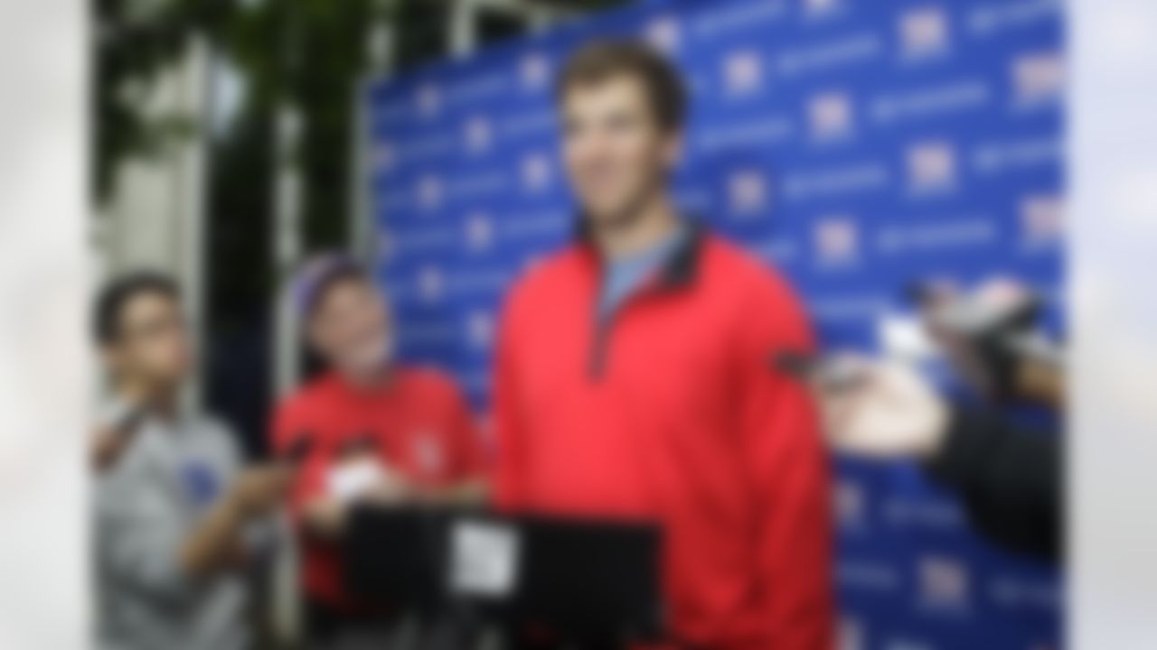 New York Giants quarterback Eli Manning speaks to reporters at NFL football training camp in Albany, N.Y., Sunday, July 29, 2012. (AP Photo/Kathy Willens)