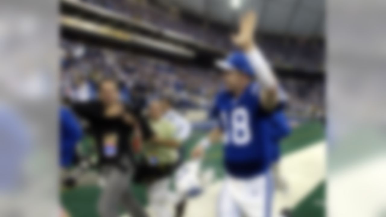Indianapolis Colts quarterback Peyton Manning waves to the fans after a 34-31 overtime win over the San Diego Chargers in Indianapolis, Sunday, Dec. 26, 2004. Manning threw his 49th touchdown of the season in the fourth quarter, breaking the single season record held by Dan Marino. (AP Photo/Michael Conroy)