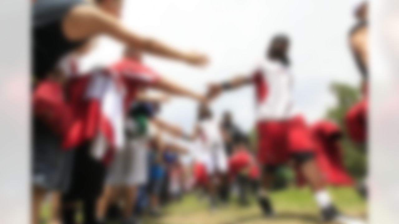 Arizona Cardinals players get high-fives from fans prior to NFL training camp football practice at Northern Arizona University Saturday, July 28, 2012, in Flagstaff, Ariz.(AP Photo/Ross D. Franklin)