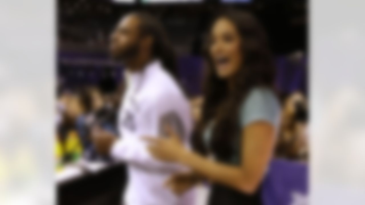 Seattle Seahawks' Richard Sherman dances with Gina Holguim during media day for NFL Super Bowl XLIX football game Tuesday, Jan. 27, 2015, in Phoenix. (AP Photo/David J. Phillip)