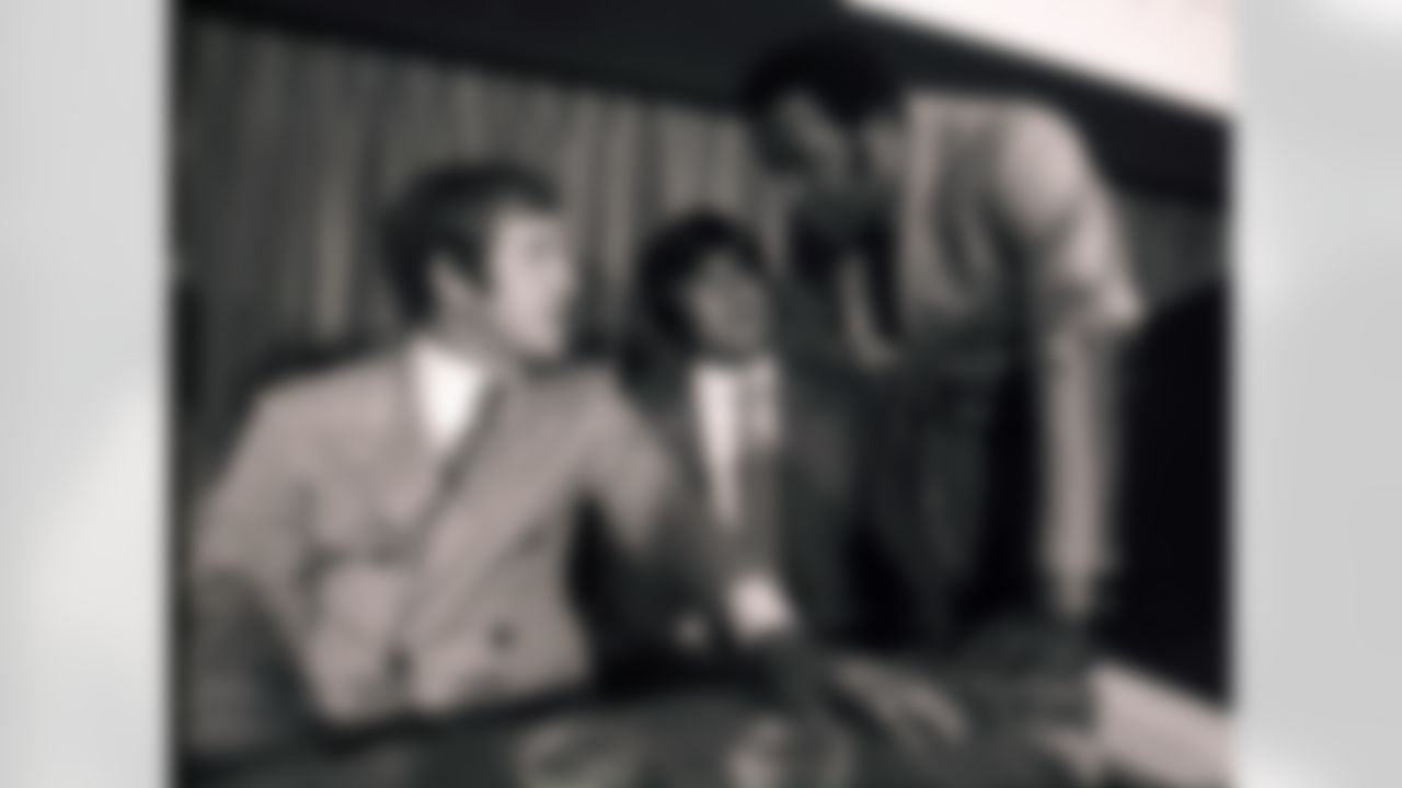 This July 20, 1970 file photo showing NFL Players Association president John Mackey, right, talking with New York Giants' Fran Tarkenton, left, and Los Angeles Rams' Roman Gabriel, center, before a news conference to discuss issues between the NFLPA and team owners, in New York. (Associated Press)