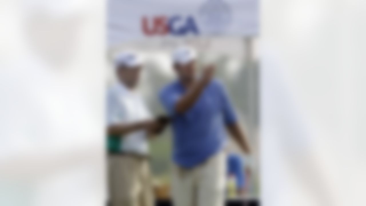 Dallas Cowboys quarterback Tony Romo, right, talks with his caddy Bob Swanson, left, before teeing off on the first hole during sectional qualifying for the 2010 U.S. Open golf tournament Monday, June 7, 2010, at the Club at Carlton Woods in The Woodlands, Texas. The U.S. Open will be played June 14-20 at Pebble Beach Golf Links in Pebble Beach, Calif. (AP Photo/David J. Phillip)