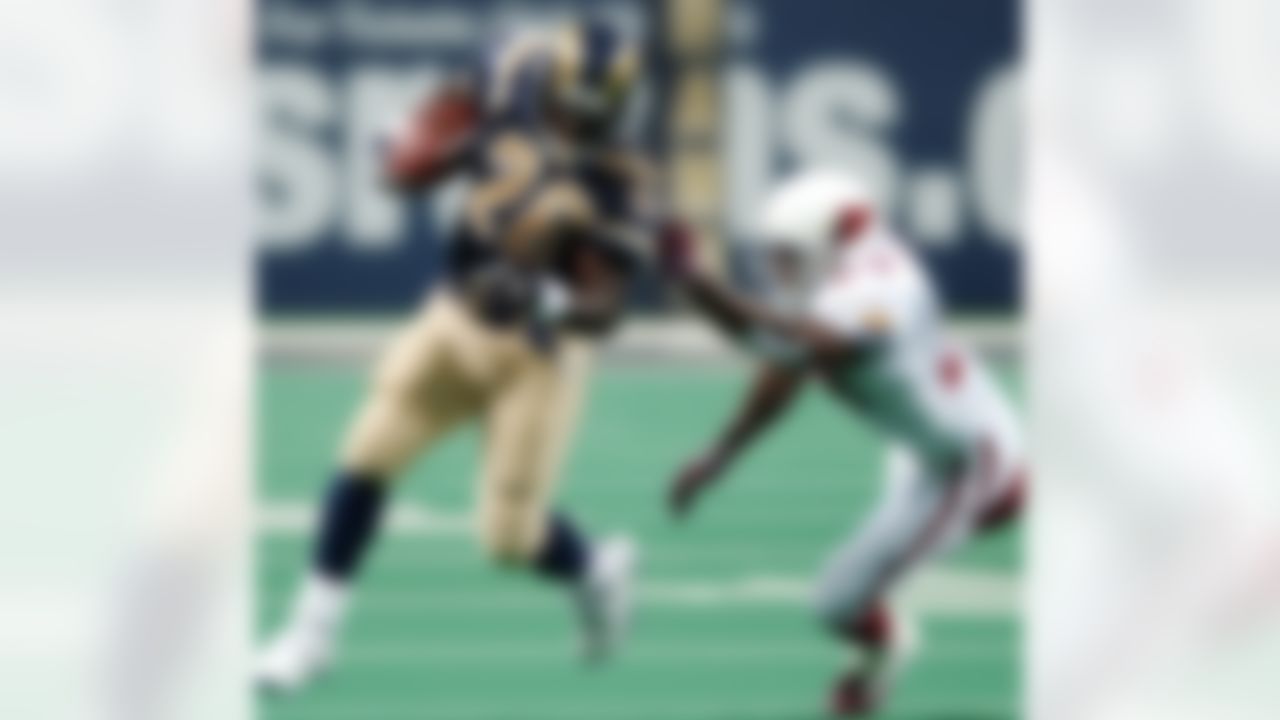 St. Louis Rams Marshall Faulk (28) turns the corner against the Arizona Cardinals Adrian Wilson for seven yards during the first half of their NFL game in St. Louis, Sunday, Sept. 12, 2004. (AP Photo/James A. Finley)