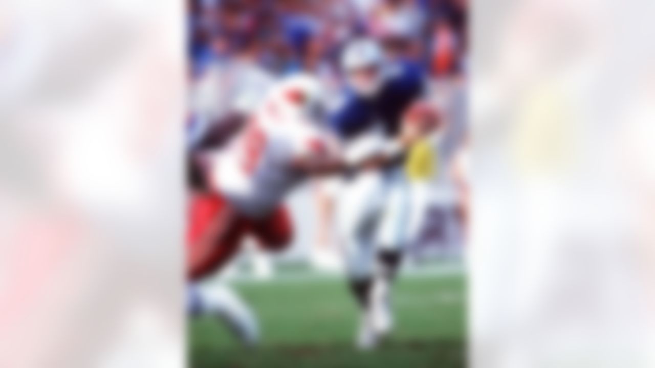 Dallas Cowboys quarterback Troy Aikman avoids a sack by Arizona Cardinals defensive lineman Keith Rucker during their 16-10 victory at Sun Devil Stadium in Tempe, Arizona on October 22, 1992. (Otto Greule/Allspot)