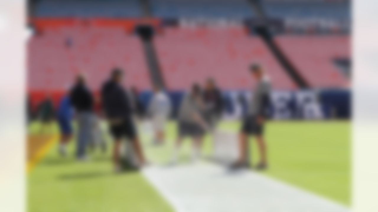 Workers put the finishing touches on the field at Sun Life Stadium in Miami Gardens, Fla. on Feb. 7, 2010. (Ben Liebenberg/NFL.com)