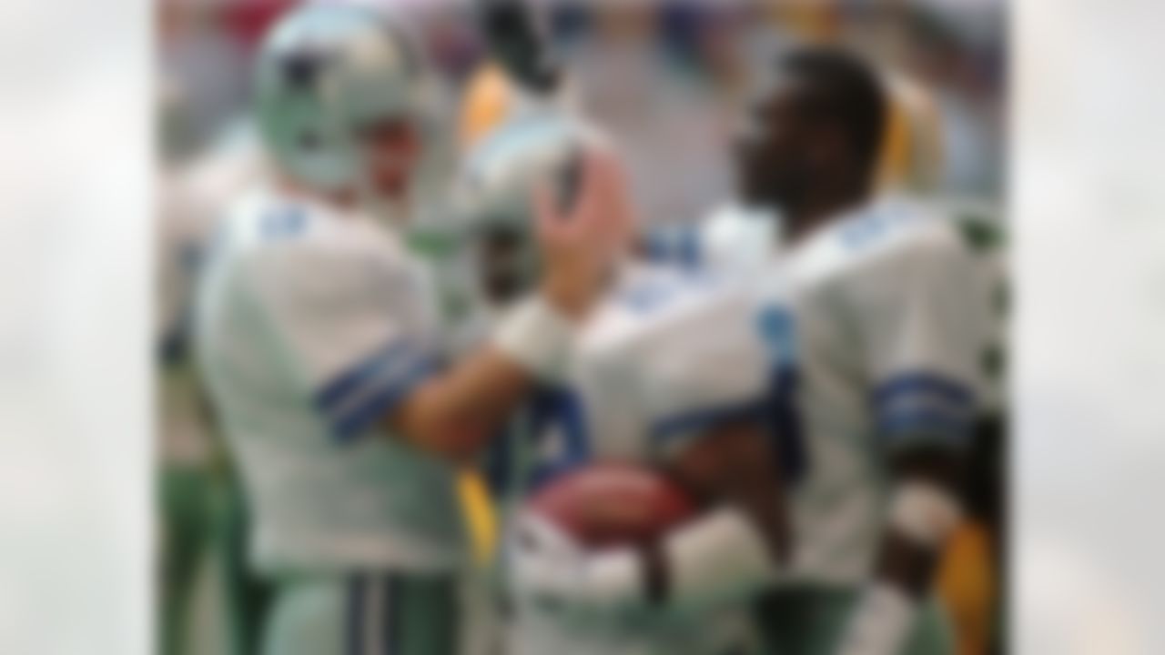 Dallas Cowboys Troy Aikman (8), Emmitt Smith (22) and Michael Irvin (88) celebrate Smith's second-quarter touchdown run in the NFC Championship game against the Green Bay Packers Sunday, Jan. 14, 1996, in Irving, Texas. (AP Photo/Tim Sharp)