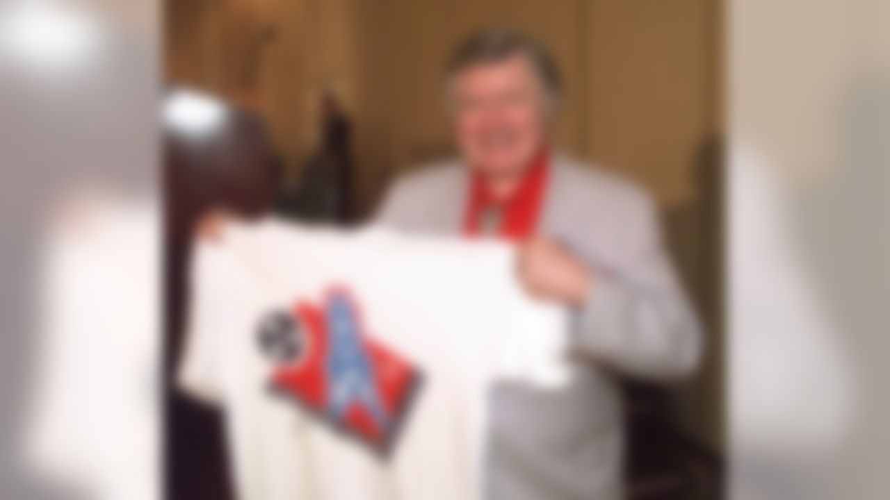 Houston Oilers owner Bud Adams shows off a T-shirt with the new logo the team will use this season when it moves to Tennessee. The logo was unveiled in Nashville on Thursday, June 12, 1997.  (AP Photo/Mark Humphrey)