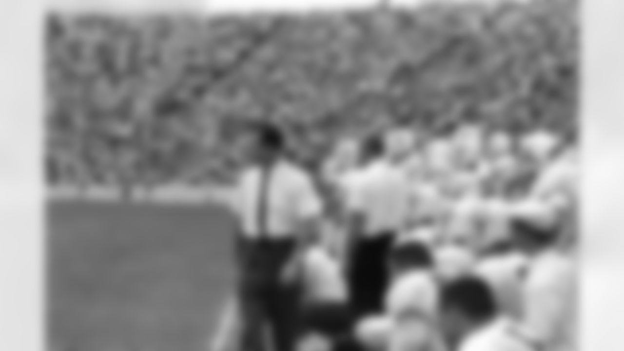 Coach Darrell Royal, left, and team members of the University of Texas had eyes for only their opponent, the University of Oklahoma at the Cotton Bowl in Dallas, Oct. 15, 1962. Texas was named the number one college team in the nation yesterday. (AP Photo/Ferd Kaufman)