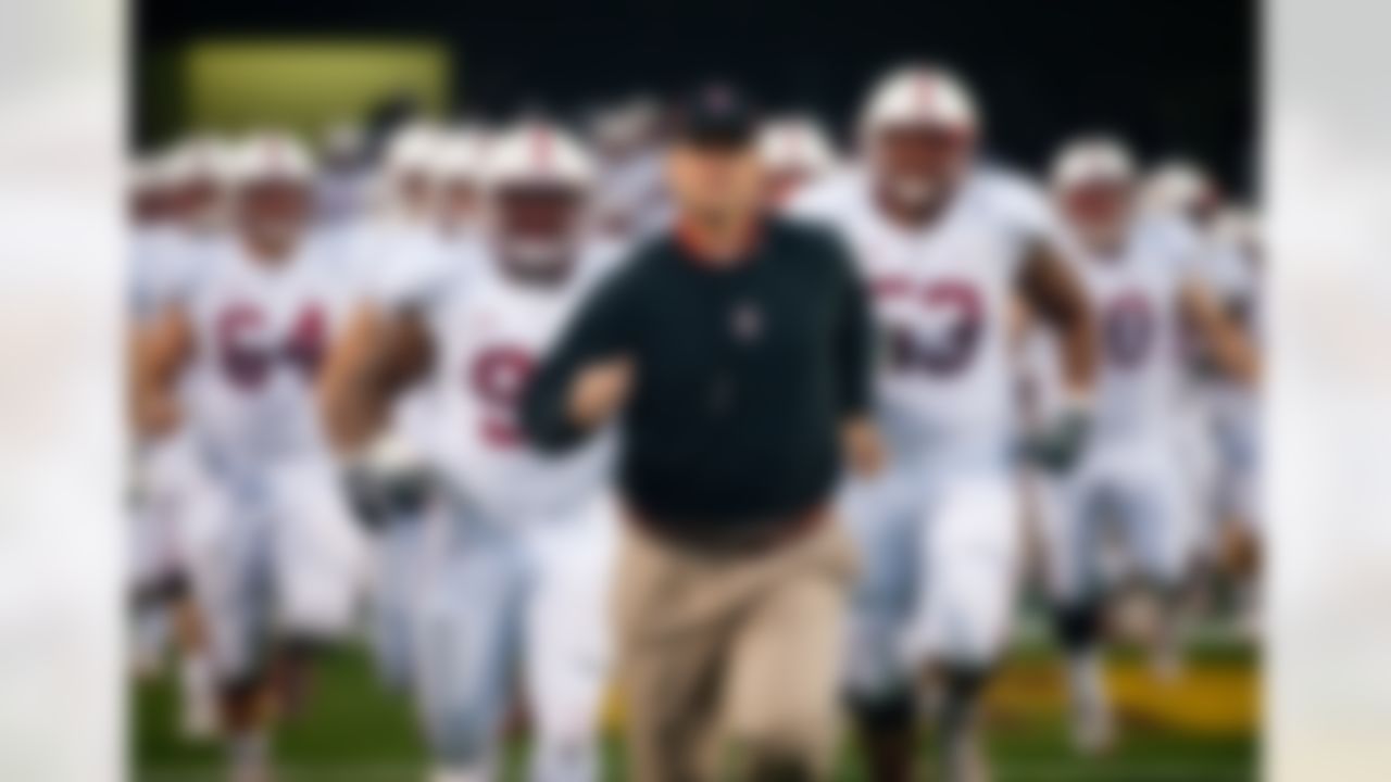 Head coach Jim Harbaugh leads the Stanford Cardinal onto the field at Arizona State University, November 13, 2010 in Tempe, Arizona. (Courtesy Stanford Athletics/StanfordPhoto.com)