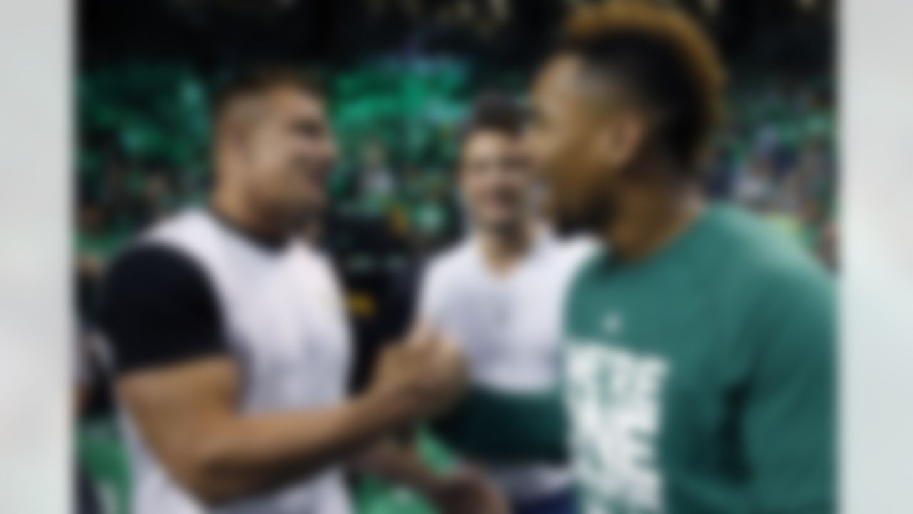 Boston Celtics' Jared Sullinger, right, greets New England Patriot's Rob Gronkowski before game 4 of a first-round NBA basketball playoff series against the Atlanta Hawks in Boston, Sunday, April, 24, 2016. (AP Photo/Michael Dwyer)