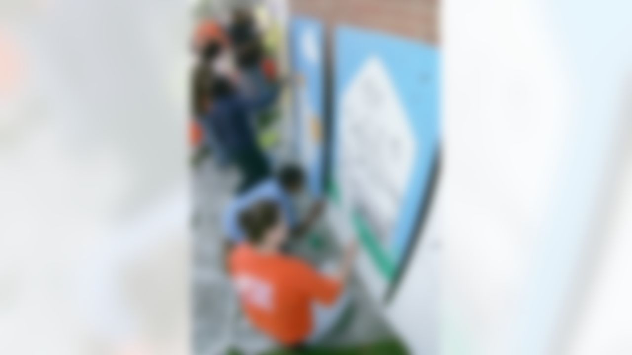 A Home Depot associate working alongside members of the Famicos Foundation. (Photo by Alan Marler/CIA Stock Photography, Inc.)