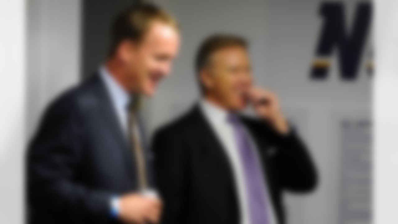 May 11, 2012; San Diego, CA, USA; Denver Broncos quarterback Peyton Manning (left) and executive vice president of football operations John Elway talk in the San Diego Chargers locker room prior to a celebration of life service to remember Junior Seau at Qualcomm Stadium. Mandatory Credit: Christopher Hanewinckel-US PRESSWIRE