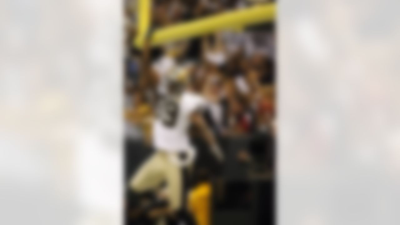 New Orleans' Curtis Deloatch (right) reacts after scoring a touchdown off a blocked punt during the first half against Atlanta Monday, September 25, 2006, at the Superdome in New Orleans, Louisiana. Photo by Getty Images.
