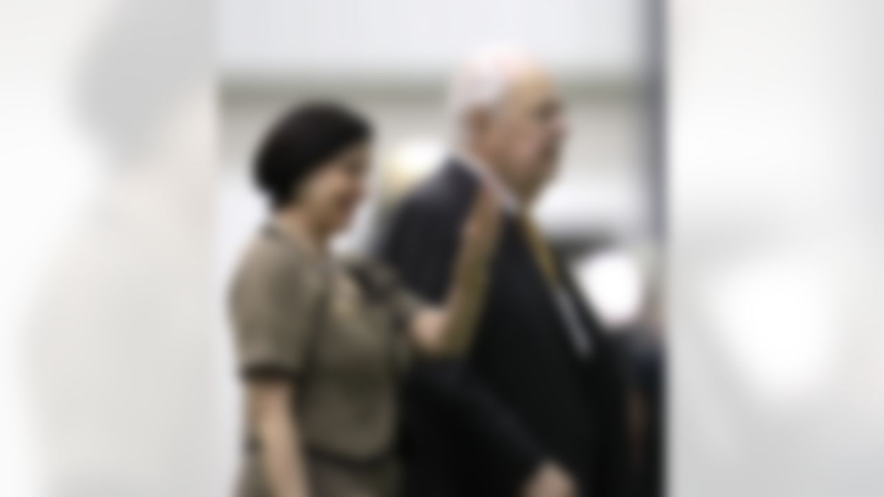 New Orleans Saints owner Tom Benson and his wife, Gayle, walk across the practice field during NFL football training camp in Metairie, La., Friday, July 27, 2012. (AP Photo/Gerald Herbert)