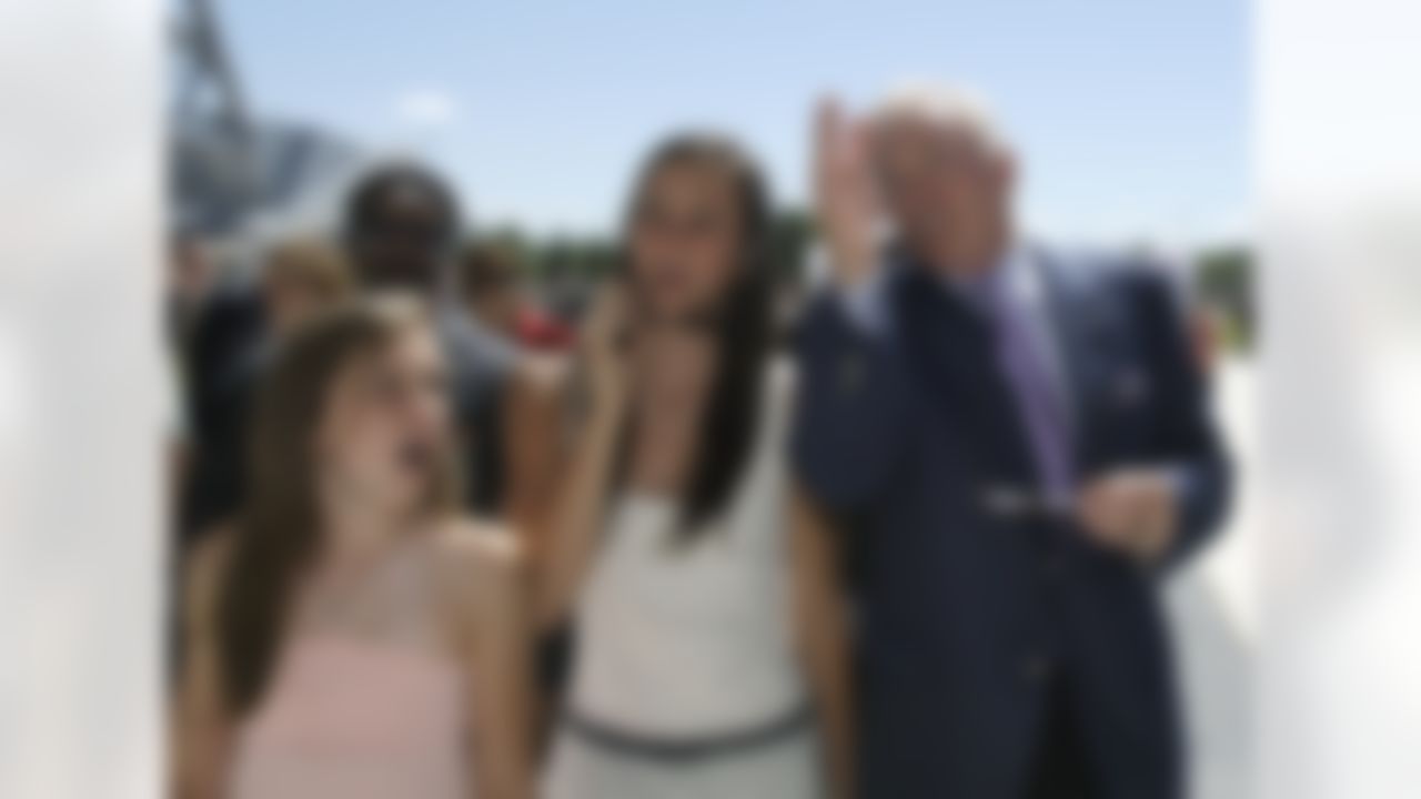 Dallas Cowboys owner Jerry Jones, right, and his grand daughters Jordan Jones, 15, center, and Caroline Jones, 12, react as they walk into the new Cowboys Stadium after a ribbon cutting ceremony, Wednesday, May 27, 2009, in Arlington, Texas. (AP Photo/Matt Slocum)