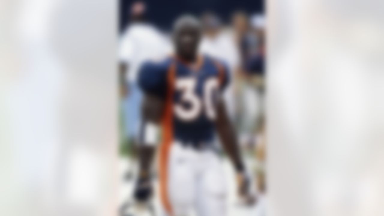 Denver Broncos running back Terrell Davis (30) watches pre-game warm-ups before an NFL game against the Dallas Cowboys in Denver, Sept. 13, 1998. The Broncos defeated the Cowboys 42-23. (AP Photo/James D. Smith)